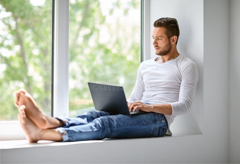 Free Stock Photo of Young Man sitting near window