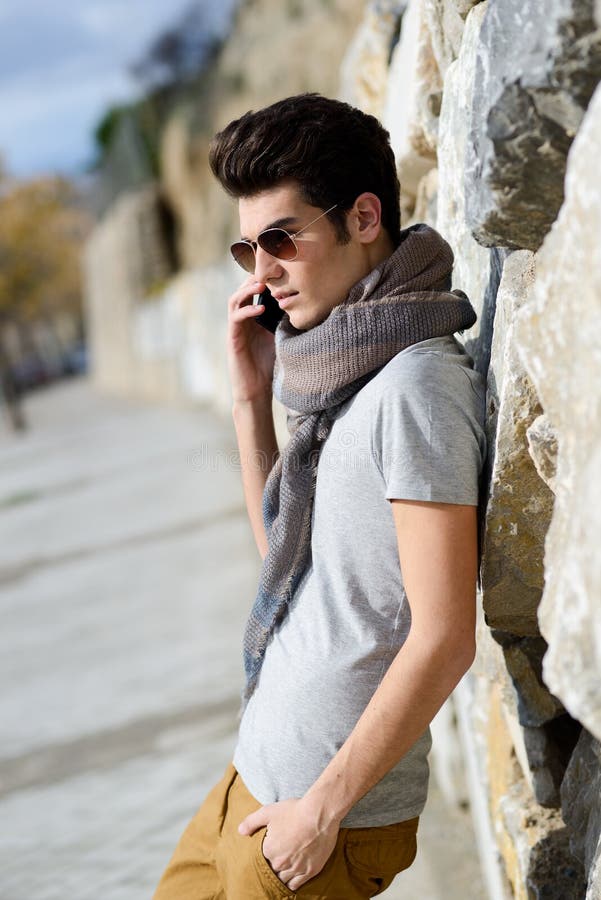 Handsome man in urban background talking on phone