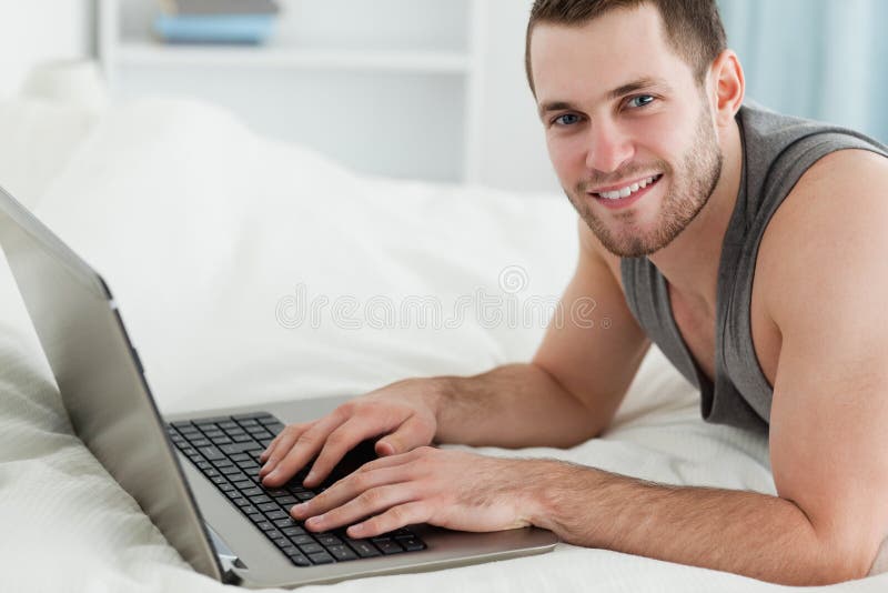 Handsome Man Using A Laptop While Lying On His Belly Stock Image Image Of Home Legs 22143853