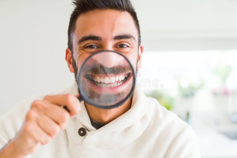 Handsome Man Using Magnifying Glass, Doing Funny Faces Stock Image