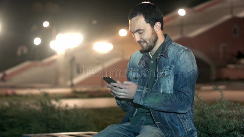 Handsome man using smart phone mobile in the city