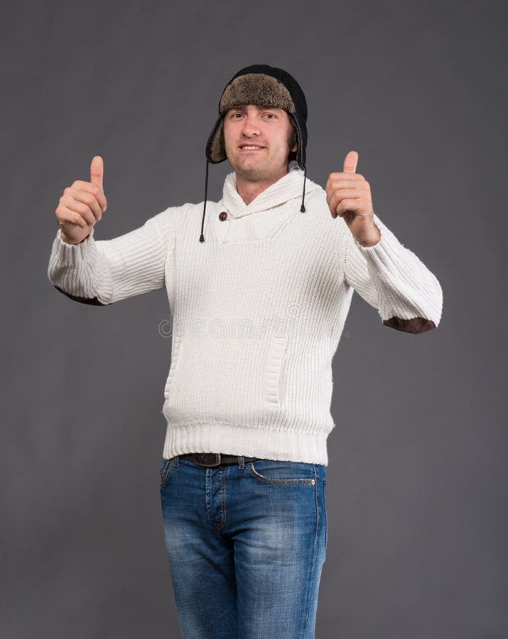 Handsome man in winter hat showing ok sign