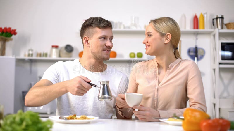 Handsome man and young woman having brewed coffee, energy boost in morning royalty free stock images Handsome man and young woman having brewed coffee, energy boost in morning royalty free stock images