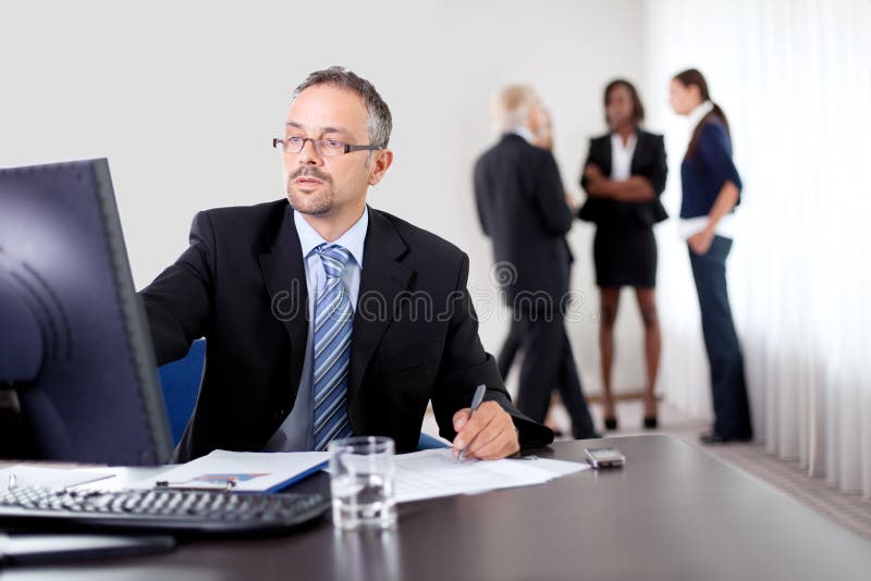 Handsome mature business man writing notes stock images