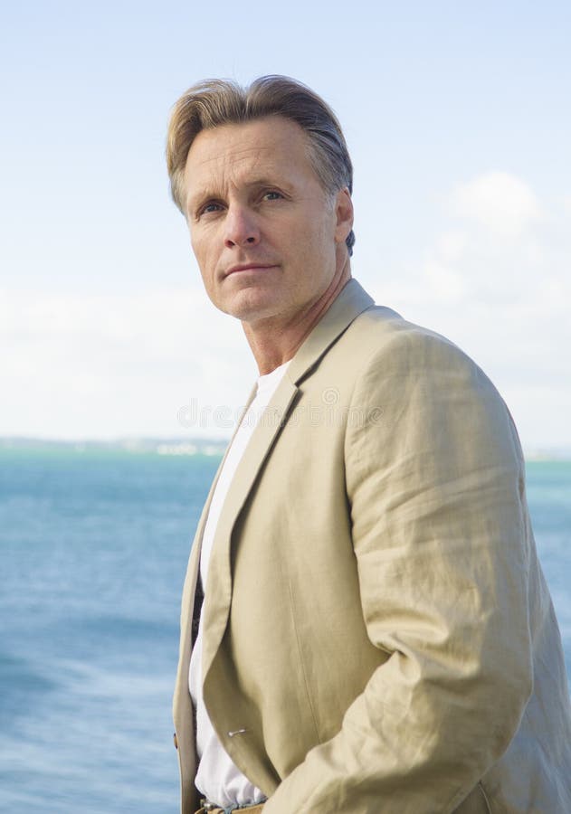 Handsome mature man in beige blazer royalty free stock image