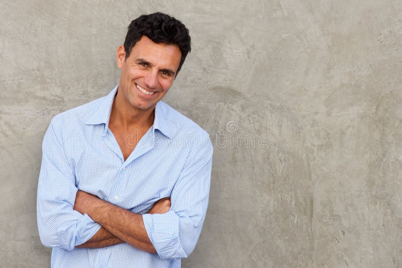 Handsome mature man standing by wall stock photos