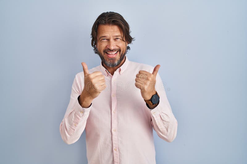 Handsome middle age man wearing elegant shirt background success sign doing positive gesture with hand, thumbs up smiling and