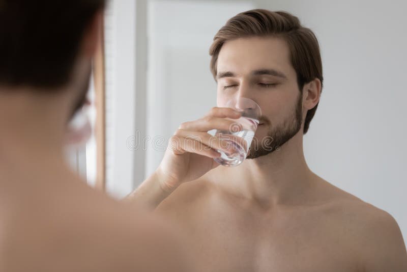 Young Man Drink Mineral Water in Bathroom Stock Photo - Image of care,  healthy: 183257348