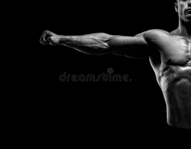 Handsome muscular bodybuilder posing and keeping arms outstretch