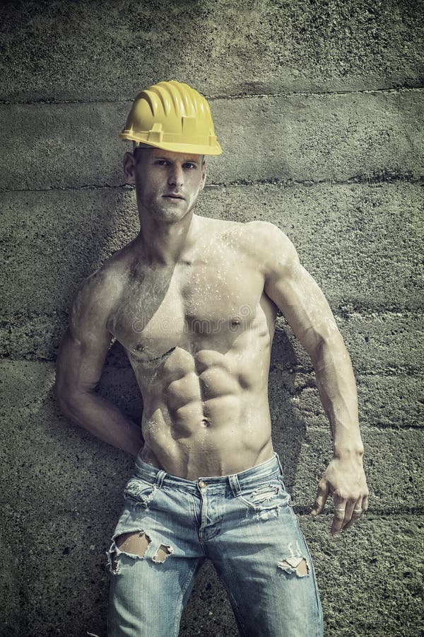 Handsome muscular construction worker standing.