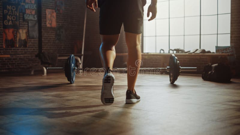 Handsome Muscular Man Does Overhead Deadlift with a Barbell in a Small Authentic Gym. Athletic royalty free stock photography