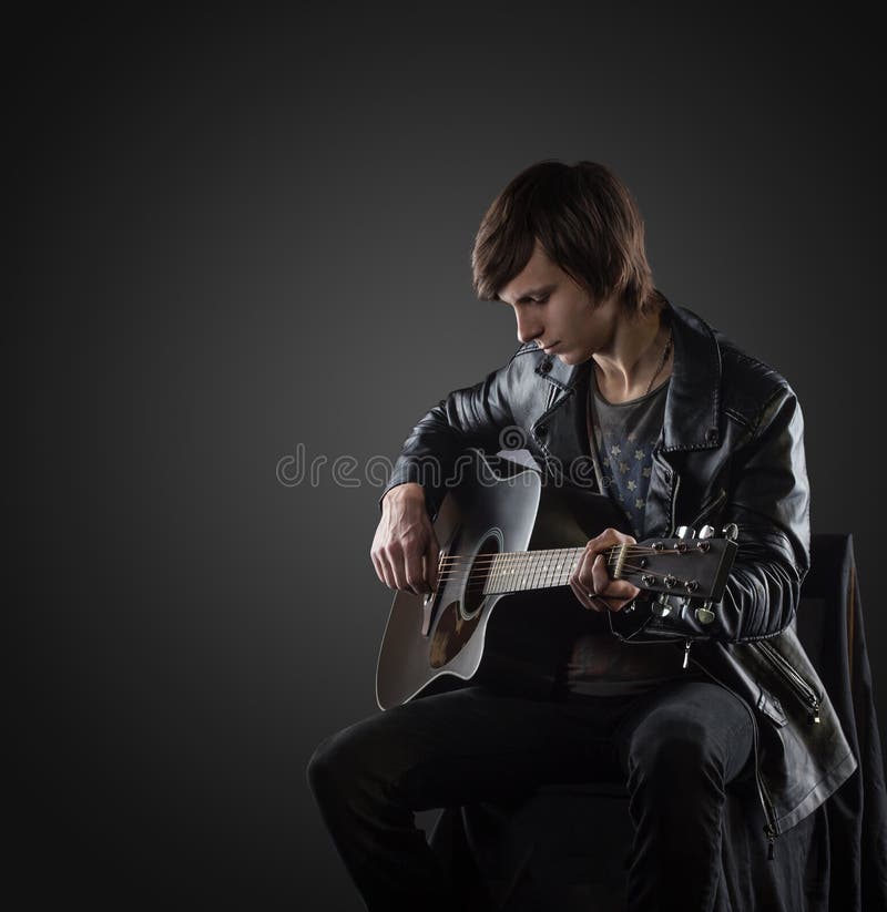 Handsome musician playing guitar royalty free stock images Handsome musician playing guitar royalty free stock images