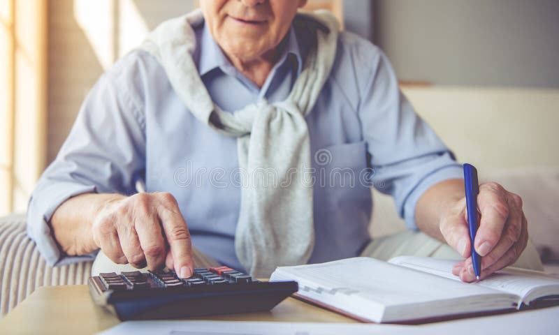 Handsome old man at home stock image. Image of notes - 78610689