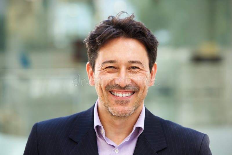 Close up portrait of handsome older man in suit with big smile on his face