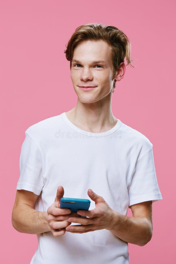 Handsome Pleasant Red Haired Guy In A White T Shirt Writes Messages