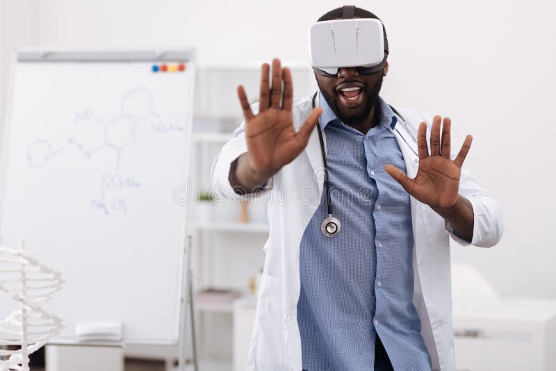 Handsome professional doctor pressing his hands to the virtual screen stock images Handsome professional doctor pressing his hands to the virtual screen stock images