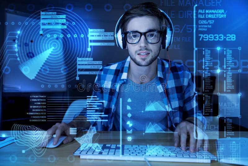 Handsome programmer listening to music while working in the office royalty free stock image