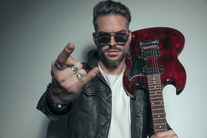 Rock and Roll Man with Guitar on Shoulder Embracing Woman Stock Image -  Image of leather, hold: 99189689