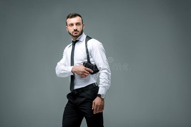 Handsome Security Guard Taking Gun And Looking Away Stock Photo - Image ...