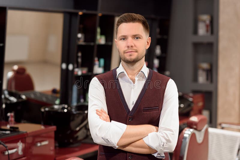 Confident barber posing and looking at camera. royalty free stock image Confident barber posing and looking at camera. royalty free stock image