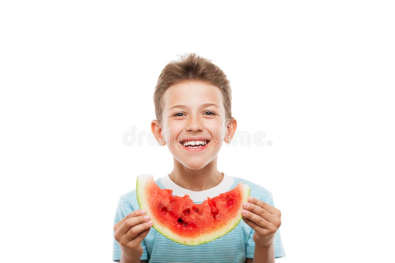 Handsome smiling child boy holding red watermelon fruit slice