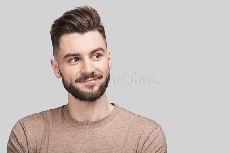 Handsome smiling young man isolated on gray background closeup portrait. Laughing joyful cheerful men studio shot