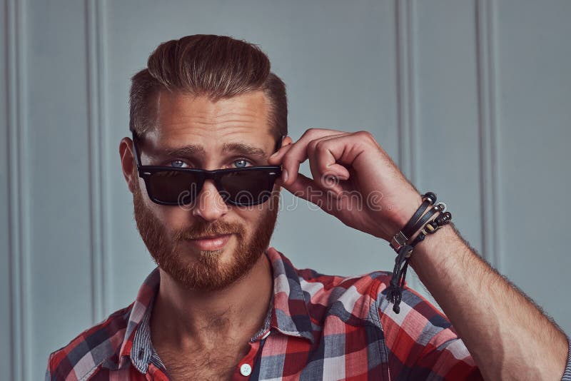 Handsome Stylish Redhead Man In A Flannel Shirt And Sunglasses, Posing ...