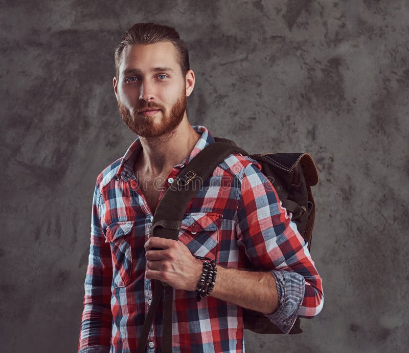 Handsome Stylish Redhead Traveler in a Flannel Shirt with a Backpack,  Posing in a Studio on a Gray Background. Stock Photo - Image of  fashionable, adult: 116125014