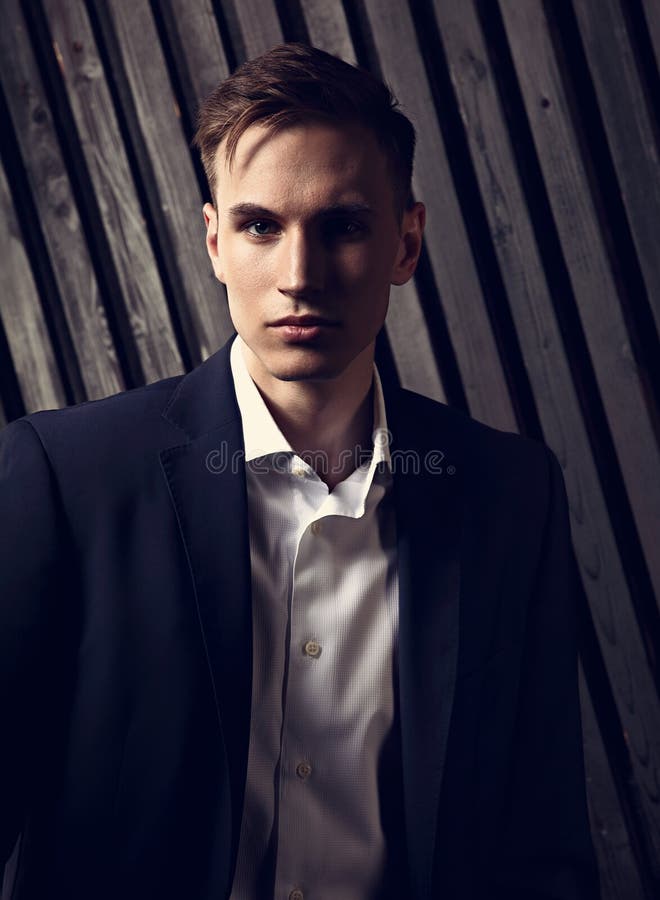 Handsome success serious young man looking in fashion suit with
