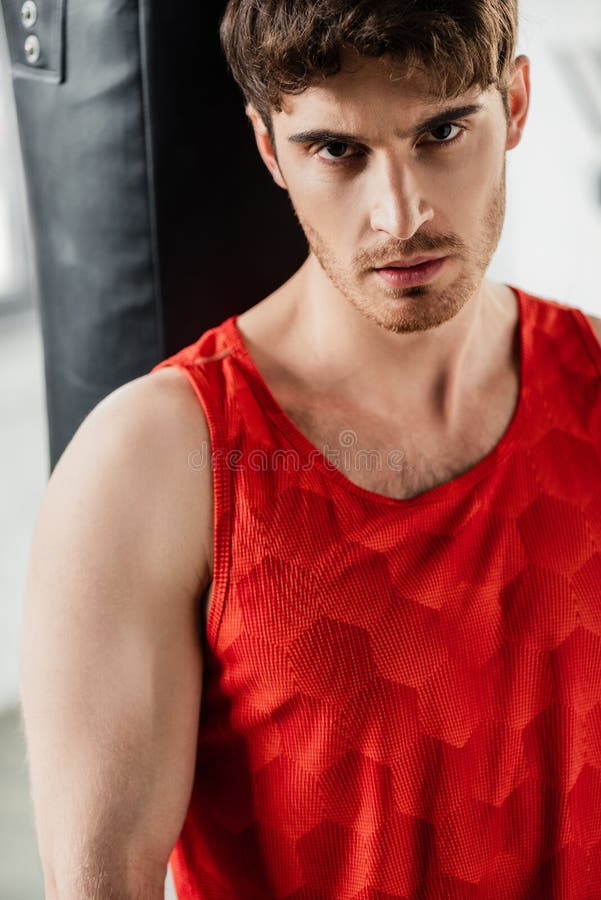 Handsome and tired sportsman looking at royalty free stock photography