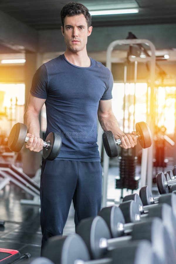 Handsome Weightlifter Lifting Bench Press Working Out with Dumbbell in