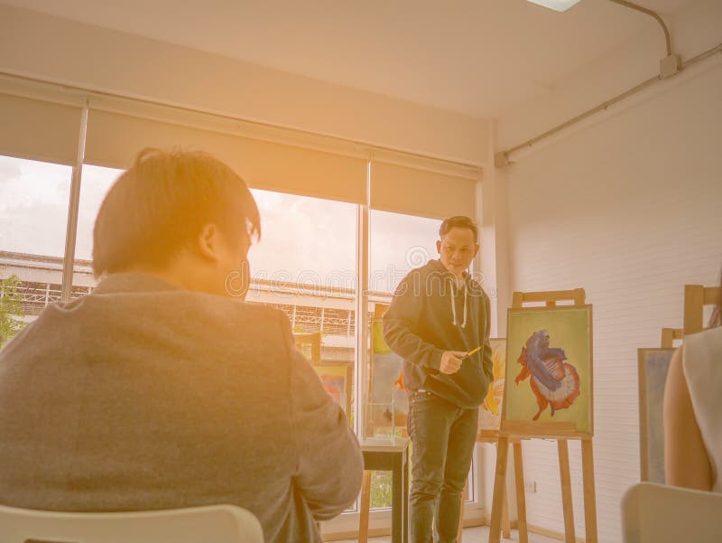 Handsome Young Asian man or water color artist Teaching how to paint in studio royalty free stock photography Handsome Young Asian man or water color artist Teaching how to paint in studio royalty free stock photography