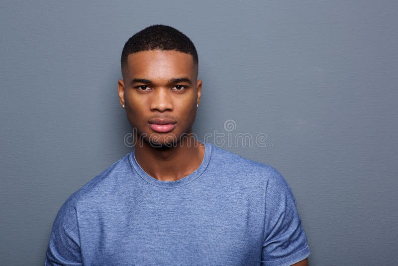 Handsome young black man with serious expression on face