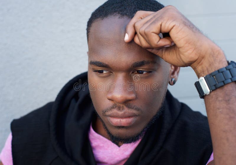 Handsome young black man thinking