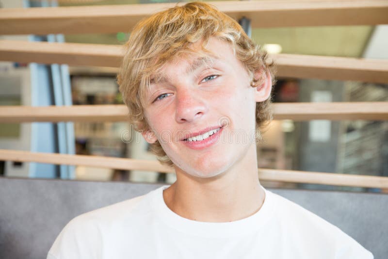 Young blond teenage boy looking at camera with quiet friendly smile royalty free stock photos Young blond teenage boy looking at camera with quiet friendly smile royalty free stock photos