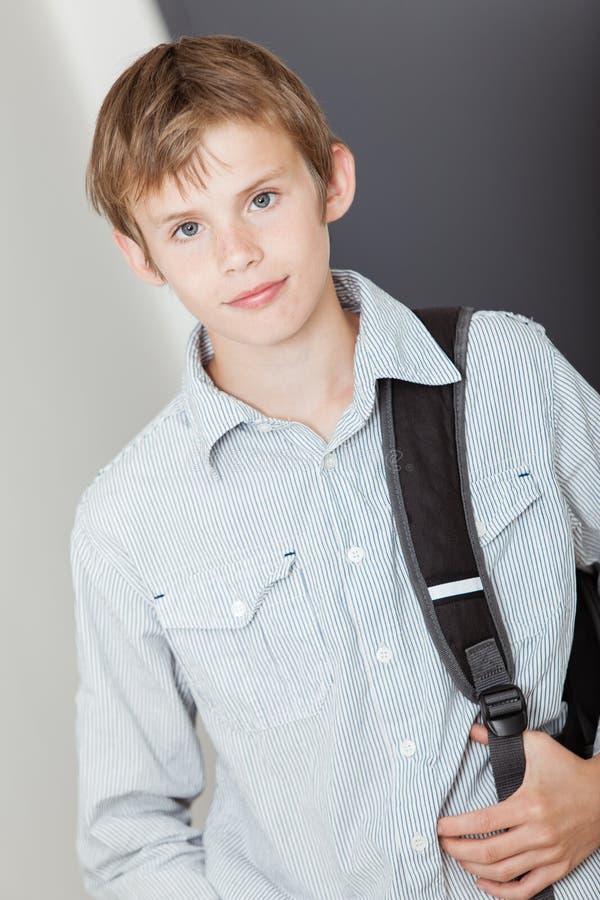 Handsome young boy with his school backpack royalty free stock photo