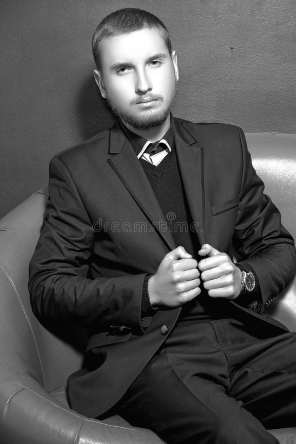 Serious Young Man in a Suit on the Sofa Stock Photo - Image of modern ...