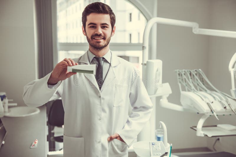 Handsome young dentist stock photo. Image of hold, portrait 91936442