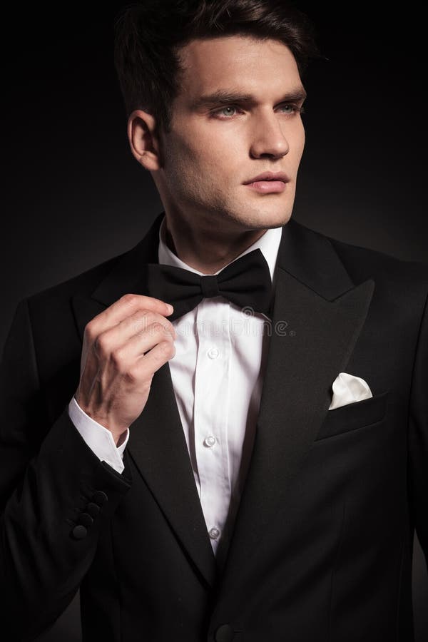 Handsome Young Elegant Man Fixing His Bowtie. Stock Image - Image of ...