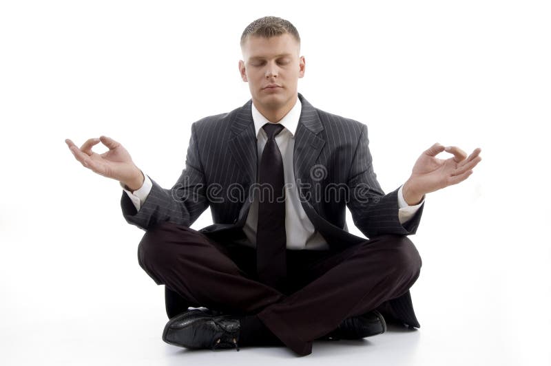 Handsome young executive practicing yoga