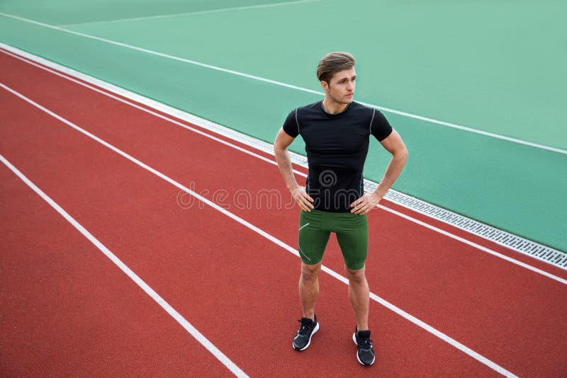 Handsome young male athlete standing outdoors royalty free stock images