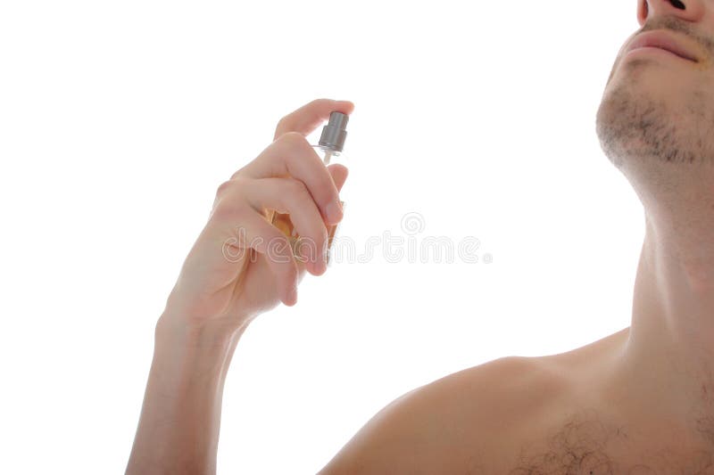 Handsome young male spray perfume on his skin royalty free stock image