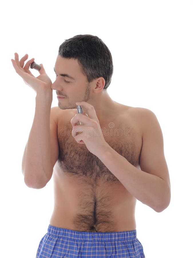 Handsome young male spray perfume on his skin royalty free stock images