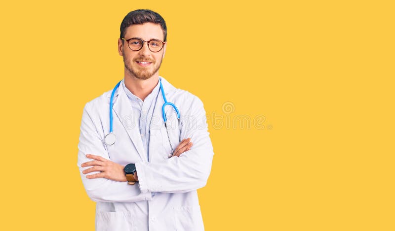 Handsome young man with bear wearing doctor uniform happy face smiling with crossed arms looking at the camera