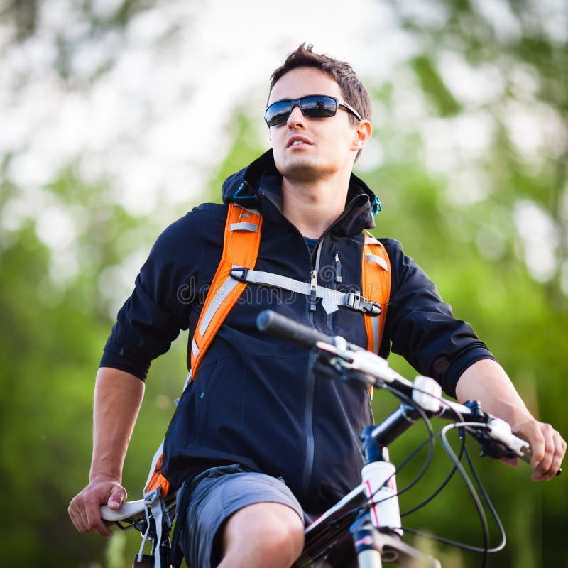 Handsome young man biking