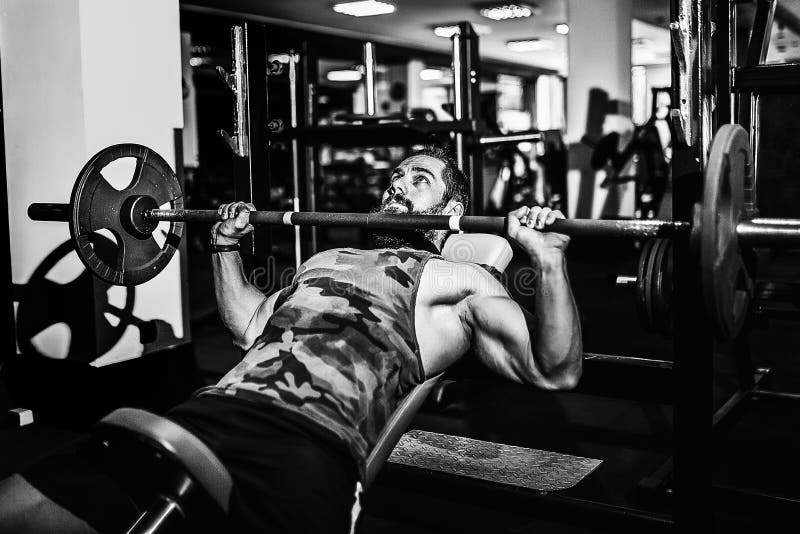 Handsome Young Man Doing Bench Press Workout in Gym Stock Photo Image