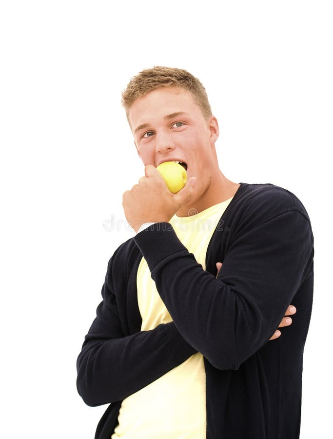 Handsome young man eating an apple royalty free stock images