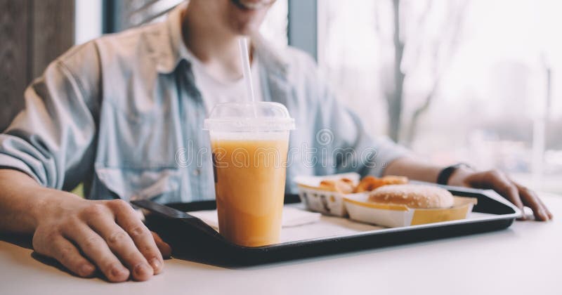 Handsome young man having lunch in cafe alone royalty free stock photo Handsome young man having lunch in cafe alone royalty free stock photo