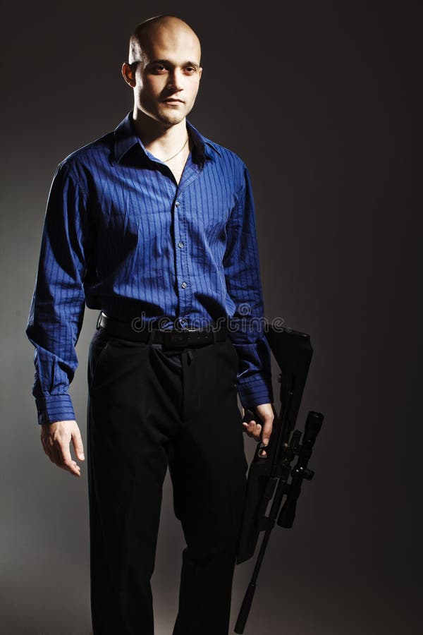 Handsome young man holding a gun.