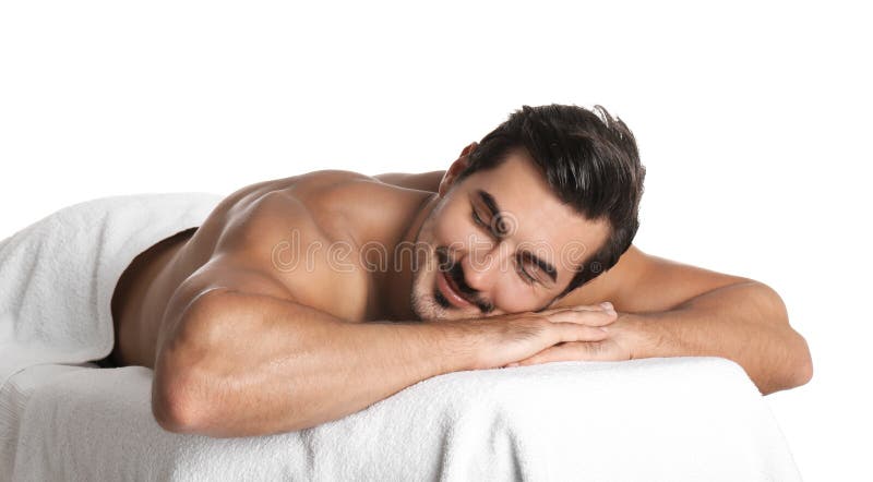 Handsome Man Relaxing On Massage Table Against White